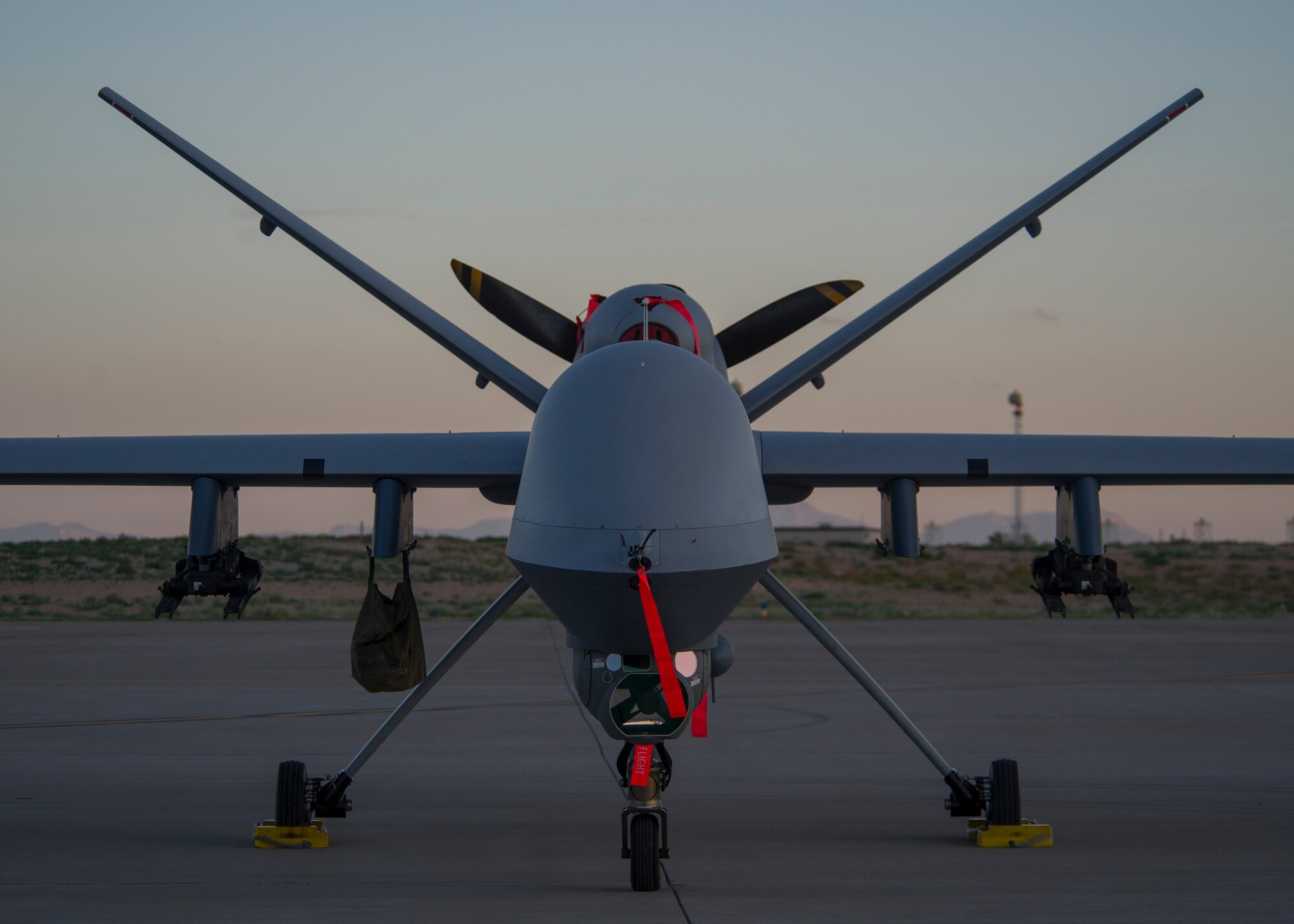 An MQ-9 Reaper sits on the flight line of Holloman Air Force Base, N.M., Aug. 19, prior to maintenance that will keep it flying and training the next generation of Air Force pilots and sensor operators. The MQ-9 Reaper is a medium-to-high altitude, long endurance unmanned aircraft system. The MQ-9's primary mission is as a persistent hunter-killer against emerging targets to achieve joint force commander objectives. The MQ-9's alternate mission is to act as an intelligence, surveillance and reconnaissance asset, employing sensors to provide real-time data to commanders and intelligence specialists at all levels.(U.S. Air Force photo by Airman 1st Class Aaron Montoya/Released)