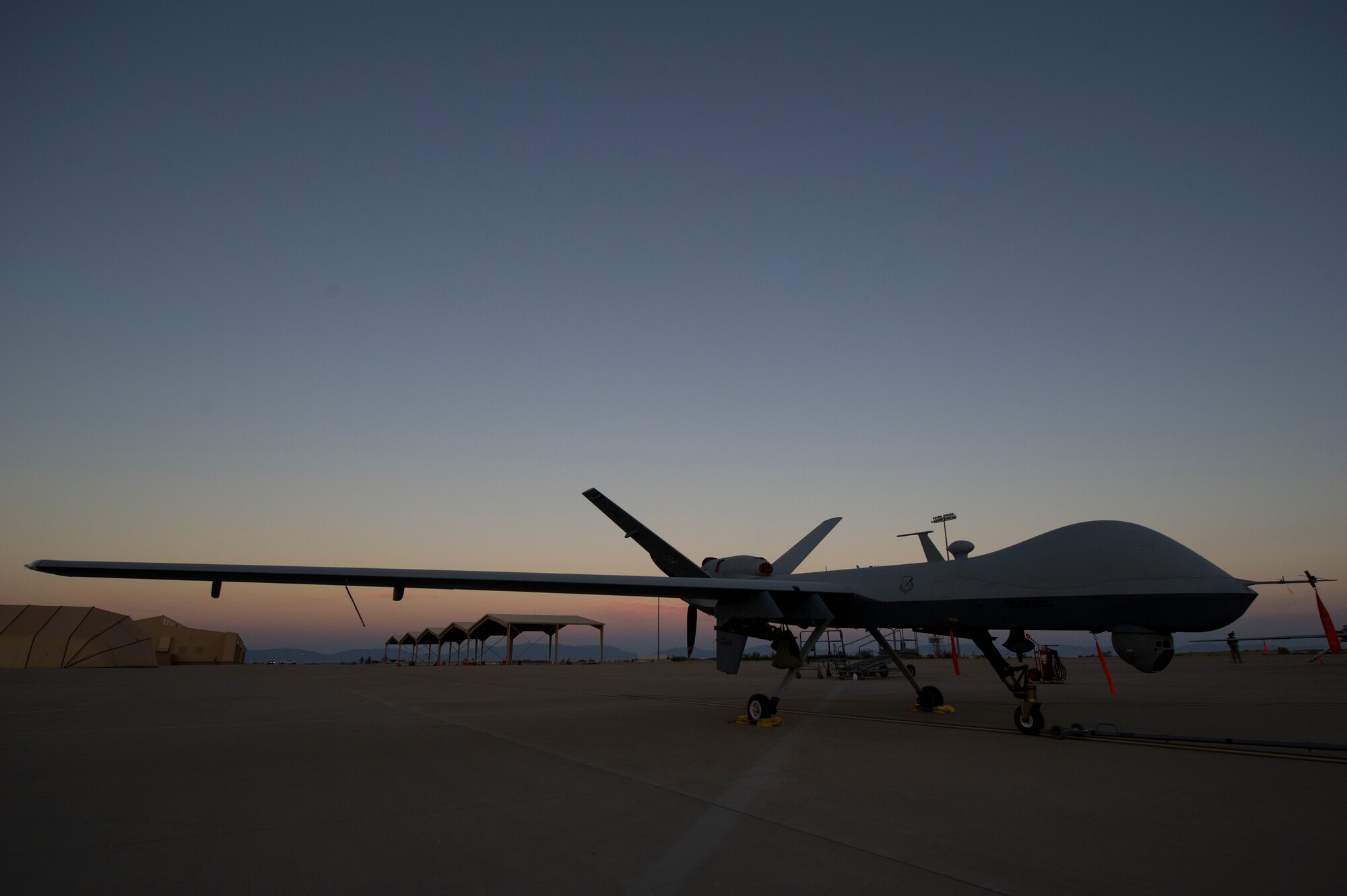 An MQ-9 Reaper sits on the flight line of Holloman Air Force Base, N.M., Aug. 19, prior to maintenance that will keep it flying and training the next generation of Air Force pilots and sensor operators. The MQ-9 Reaper is a medium-to-high altitude, long endurance unmanned aircraft system. The MQ-9's primary mission is as a persistent hunter-killer against emerging targets to achieve joint force commander objectives. The MQ-9's alternate mission is to act as an intelligence, surveillance and reconnaissance asset, employing sensors to provide real-time data to commanders and intelligence specialists at all levels.(U.S. Air Force photo by Airman 1st Class Aaron Montoya/Released)
