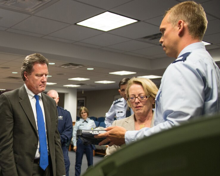 HANSCOM AIR FORCE BASE, Mass. – Capt. Matthew Holland, Global Broadcast Service Division deputy program manager, demonstrates equipment to U.S. Reps. Michael Turner of Ohio and Niki Tsongas of Massachusetts, both members of the House Armed Services Committee, during a visit here Aug. 19. Turner and Tsongas came to Hanscom and the adjacent MIT Lincoln Laboratory for briefings and demonstrations after doing much the same at Wright-Patterson AFB in Ohio the previous day. (U.S. Air Force photo by Mark Herlihy)