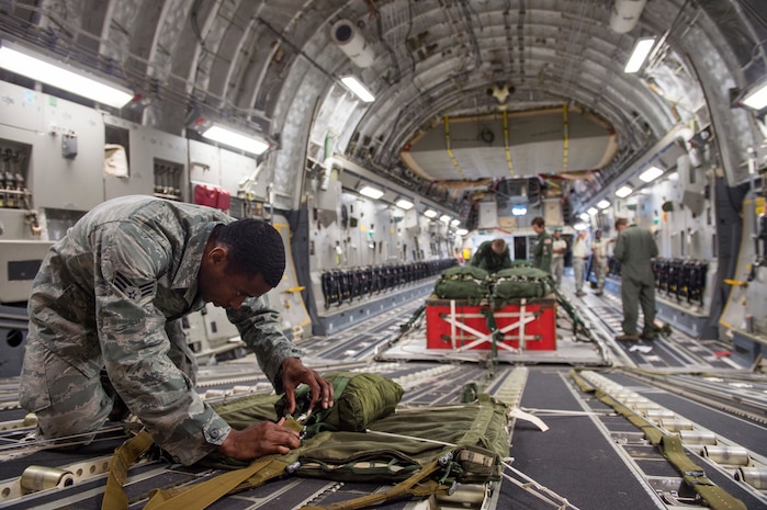 Senior Airman Daniel Cherry, 437th Operations Support Squadron loadmaster, checks over an extraction line bag, Aug. 19, 2014, at Joint Base Charleston, S.C. The ELB is used to deploy the parachute to pull cargo out of the aircraft. (U.S. Air Force photo/Senior Airman George Goslin)