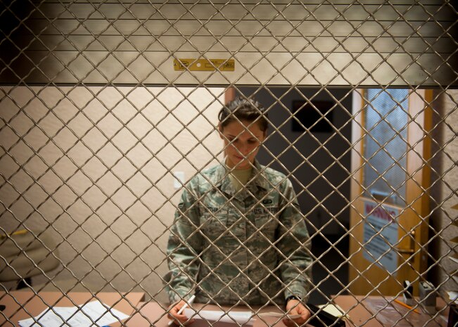 Airman 1st Class Olga Buzhak, 99th Comptroller Squadron customer service technician, processes paperwork in the vault at Nellis Air Force Base, Nev., Aug. 18, 2014. The Nellis finance office, which has the largest customer flow of all Air Combat Command bases, fields anywhere from 150-200 customer inquiries every day. (U.S. Air Force photo by Staff Sgt. Siuta B. Ika)