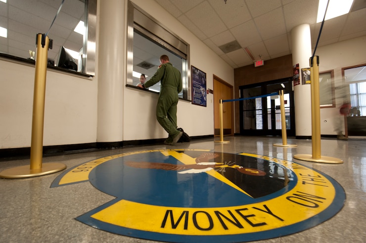 2nd Lt. Kelly, 17th Reconnaissance Squadron pilot, processes his paperwork at the 99th Comptroller Squadron finance office at Nellis Air Force Base, Nev., Aug. 18, 2014. The 99th CPTS provides financial customer service to members of Nellis and Creech AFBs, and the Nevada Test and Training Range by executing budgets to fund all mission requirements. (U.S. Air Force photo by Airman 1st Class Thomas Spangler)