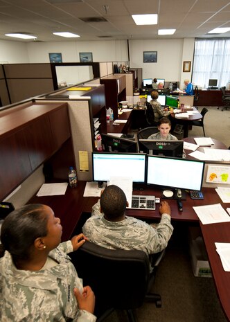 Airmen from the 99th Comptroller Squadron Financial Services and Analysis flights go over records at Nellis Air Force Base, Nev., Aug. 18, 2014. The 99th CPTS mission is to deliver world-class customer support and financial services to the warriors of Nellis and Creech AFBs, and the Nevada Test and Training Range. (U.S. Air Force photo by Airman 1st Class Thomas Spangler)