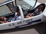 Cadet 3rd Class Kenneth McGhee, upgrader (front seat), and Cadet 2nd Class Miranda Mila instructor pilot (back seat), prepare for a training flight in a TG-16A glider Aug.15. (U.S. Air Force photo/Amber Baillie)