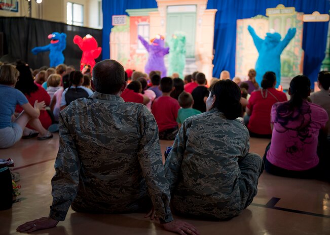 Nellis, Creech and Nevada Test and Training Range Airmen and family members watch a Sesame Street/USO Experience for Military Families show at the Youth Center, Nellis Air Force Base, Nev., Aug. 15, 2014. The show was designed to help military families cope with issues unique to the military way of life. (U.S. Air Force photo by Airman 1st Class Mikaley Towle)