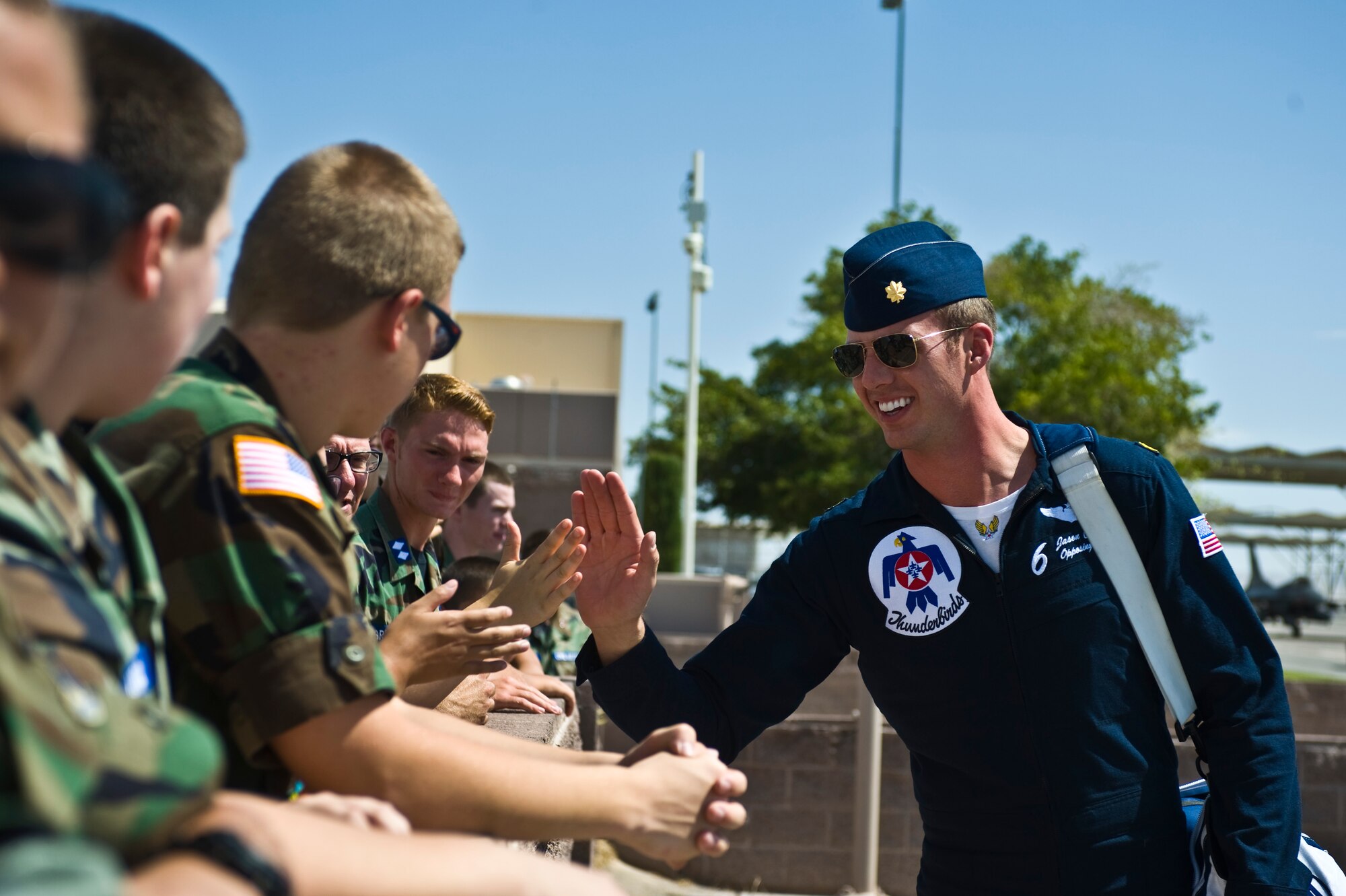 Maj. Jason Curtis, U.S. Air Force Air Demonstration Squadron no. 6 pilot, interacts with Civil Air Patrol cadets at Nellis Air Force Base, Nev., Aug. 18, 2014. The CAP cadets were visiting the base to tour the Thunderbirds museum and the Threat Training Facility to gain more insight about the Air Force. (U.S. Air Force photo by Senior Airman Christopher Tam)