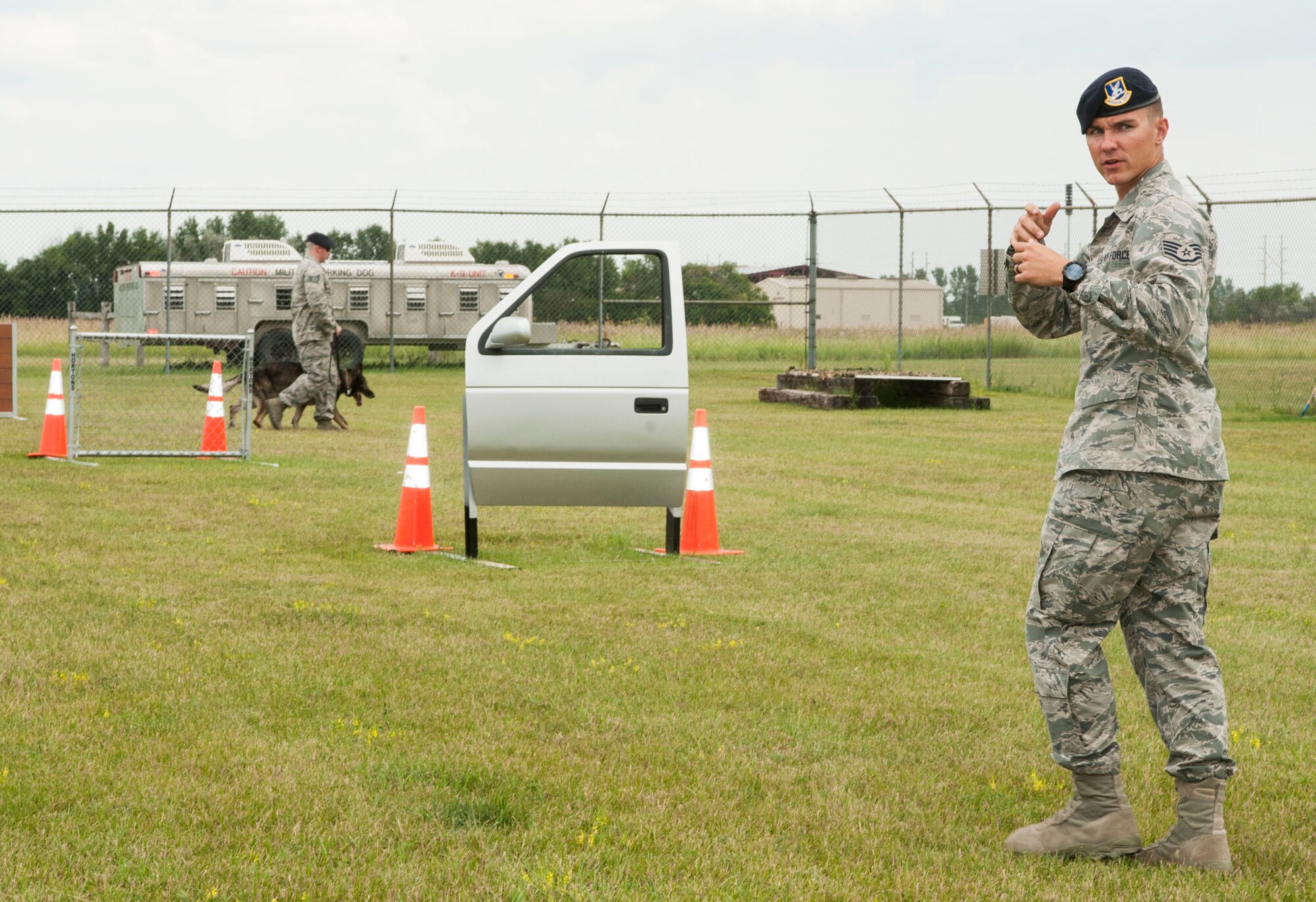 Staff Sgt. Christopher Averill, 5th Security Forces Squadron military working dog trainer, gives instructions to a MWD handler during weapons training on Minot Air Force Base, N.D., July 29, 2014. Averill attended a class similar to the kennel master course at Lackland to become the trainer for Minot AFB. As such, he is well versed in procedures and expectations for MWD handlers. (U.S. Air Force photo/Senior Airman Stephanie Morris)