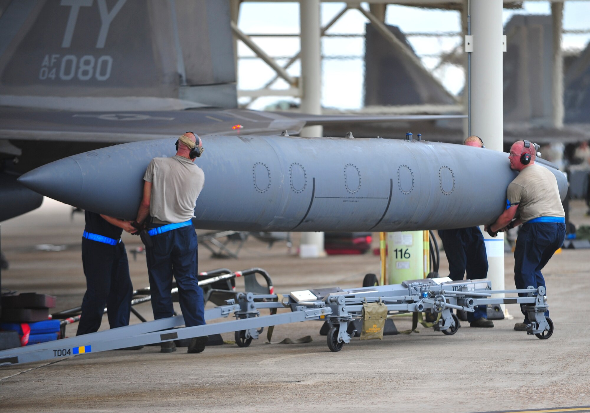 Team Tyndall members lift an F-22 Raptor external fuel tank during the week-long deployment exercise Aug. 13. The 325th Maintenance Group’s main mission throughout the exercise was to get Tyndall’s F-22s ready for war and, once at the simulated deployed location, keep them mission capable. (U.S. Air Force photo by Airman 1st Class Dustin Mullen)