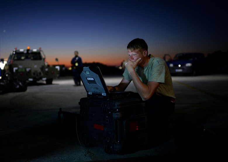 U.S. Air Force Senior Airman Alec Vautherot, 52nd Aircraft Maintenance Squadron 480th Aircraft Maintenance Unit electrical environmental specialist and native of Waterford, Mich., reviews a technical order before beginning preventative maintenance on a U.S. Air Force F-16 Fighting Falcon fighter aircraft at Souda Bay, Greece, Aug. 20, 2014. The equipment Vautherot uses must be checked out each morning from a controlled supply line. (U.S. Air Force photo by Staff Sgt. Daryl Knee/Released)