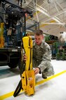 Staff Sgt. Kyle Hart, 341st Security Forces Group Tactical Response Force flight chief, learns how to use a personnel extraction device Aug. 11, in preparation for the Global Strike Challenge. The device is attached to a helicopter’s hoist cable and allows a person to sit on the paddles while being lifted off the ground. (U.S. Air Force photo/Airman 1st Class Collin Schmidt)