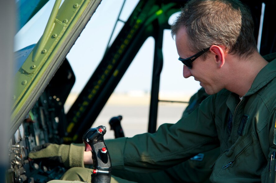 Capt. Joe Burchell, 40th Helicopter Squadron instructor pilot, adjusts the low altitude bug on a radar altimeter in preparation for flight Aug. 11. This instrument gives pilots an indication of actual altitude over the ground and displays an alert if the helicopter gets too low. (U.S. Air Force photo/Airman 1st Class Collin Schmidt)