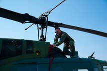 Staff Sgt. Bob Kohlenberg, 40th Helicopter Squadron instructor flight engineer, pulls the intake plug on the number two engine of a UH-1N helicopter during a pre-flight check at Malmstrom’s helicopter squadron Aug. 11.  Protective equipment like these engine plugs ensure that Malmstrom’s aircraft are ready to fly at a moment’s notice and are always protected from the elements. (U.S. Air Force photo/Airman 1st Class Collin Schmidt)