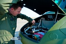 Tech. Sgt. Justin Nissen, 40th Helicopter Squadron instructor flight engineer, checks the integrity of connectors to a very high frequency Omni-directional radio range box, a piece of equipment that is part of the helicopter’s navigation system, during a pre-flight check Aug. 11. This system is essential to the safety and performance of the flight team that operates these machines on a daily basis. (U.S. Air Force photo/Airman 1st Class Collin Schmidt)