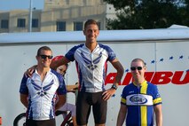 2nd Lt. Matt Bell, a student pilot in the 3rd Flying Training Squadron, stands on top of the winner’s block after taking first place in the Men’s Category Five Criterium race, and 2nd Lt. Patrick Fausel, a student pilot in the 71st Student Squadron, stands next to him after taking second. The lieutenants finished just seconds apart during the evening race in Enid, Oklahoma, Aug. 16. (U.S. Air Force Courtesy Photo)