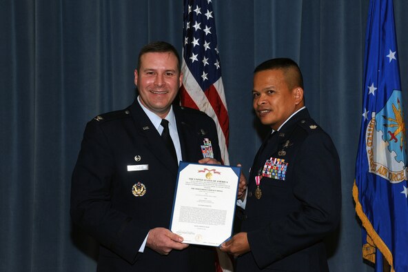 Col. Chad Raduege, left, 690th Cyberspace Operations Group commander, awards the Meritorious Service Medal to departing commander Lt. Col. Eric Trias, 690th Network Support Squadron commander, at Maxwell-Gunter Annex, Ala., Aug. 15, 2014.Trias is going on to become the Chief of Enterprise Architecture at the Pentagon.( U.S Air force photo by Airman 1st Class Alexa Culbert)