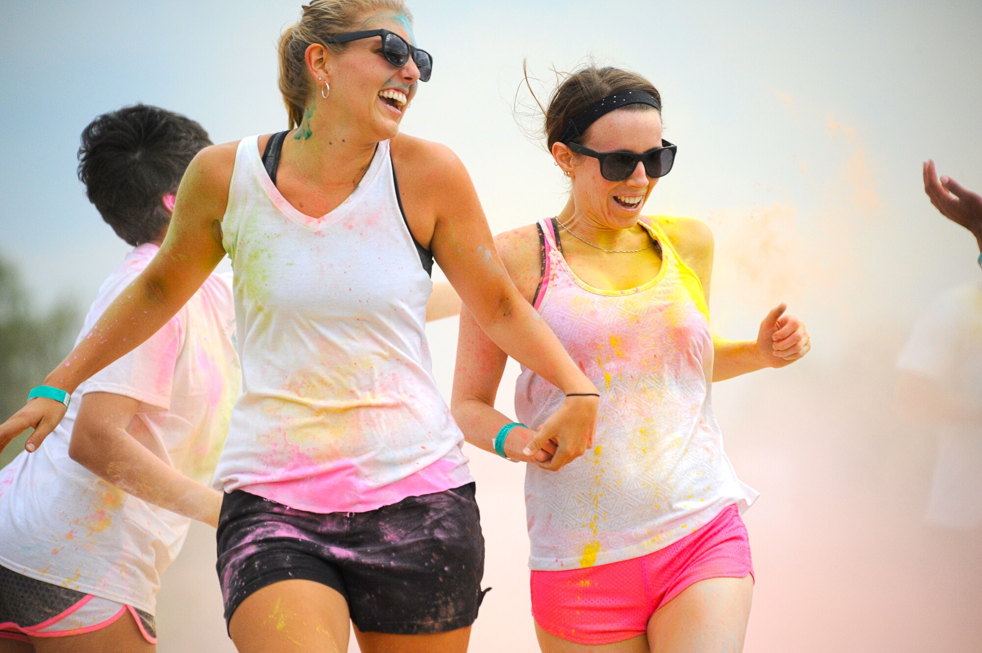 GOODFELLOW AIR FORCE BASE, Texas – Runners race through a cloud of colored powder during the Sexual Assault Prevention and Response Color Race on Kiowa Trail Aug. 16. The SAPR Office hosted the 5K run for the second year to promote awareness of sexual assault prevention (U.S.  Air Force photo/ Staff Sgt. Austin Knox)