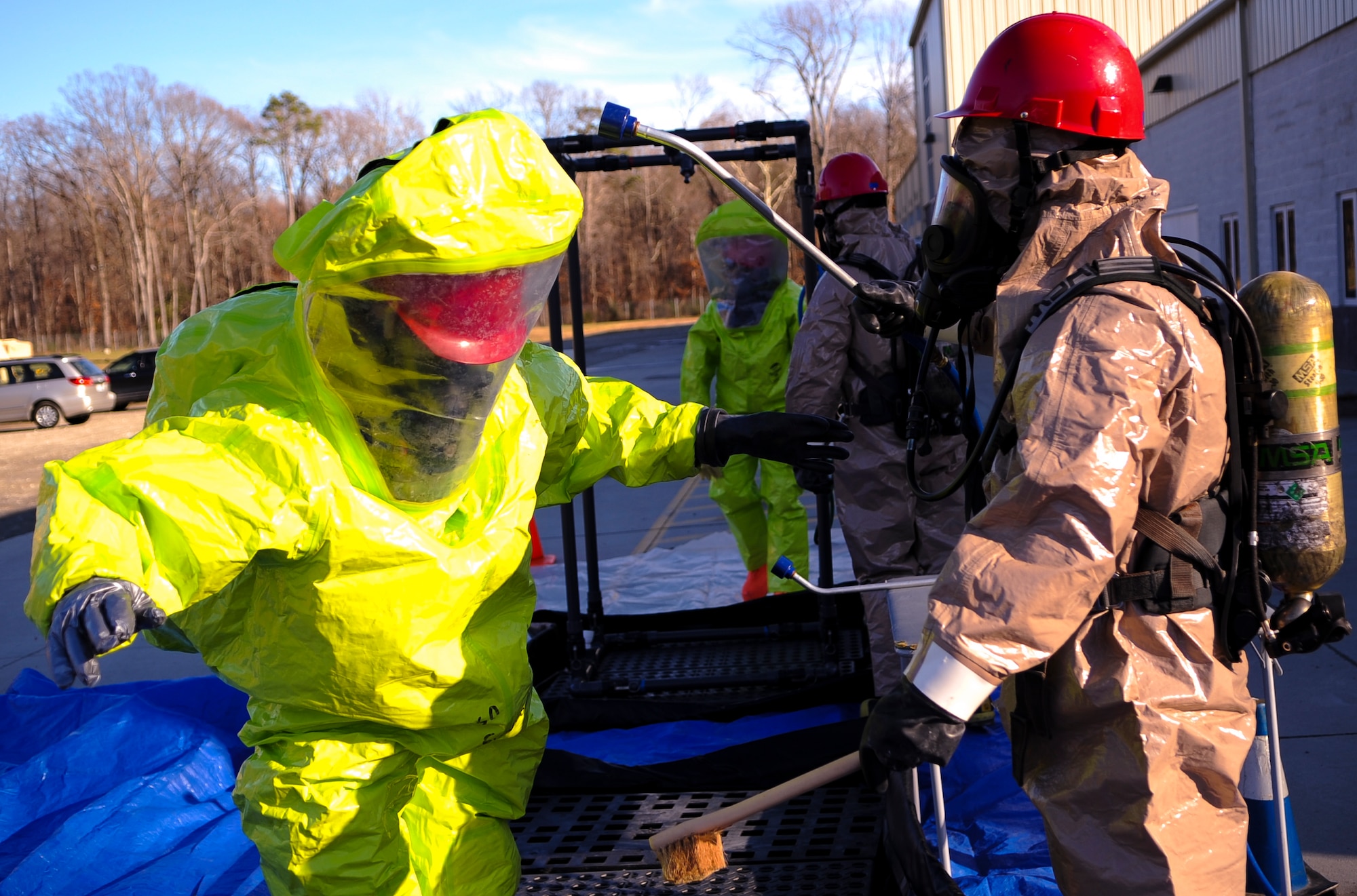 Firefighters from the 733rd Civil Engineer Division simulate a decontamination procedure during a hazardous material exercise at Fort Eustis, Va., Dec. 11, 2013. The Fort Eustis fire department trains for a wide range of emergencies, from chemical clean-up to first-aid techniques. (U.S. Air Force photo by Airman 1st Class Austin Harvill/Released)