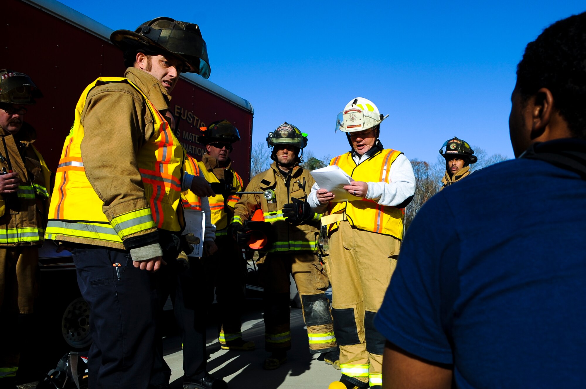 733rd Civil Engineer Division firefighters listen to a safety brief during a hazardous material exercise at Fort Eustis, Va., Dec. 11, 2013. During exercises, firefighters strive to mirror real-world threats by including all contingency operations, briefings and setup required in an actual incident. (U.S. Air Force photo by Airman 1st Class Austin Harvill/Released)