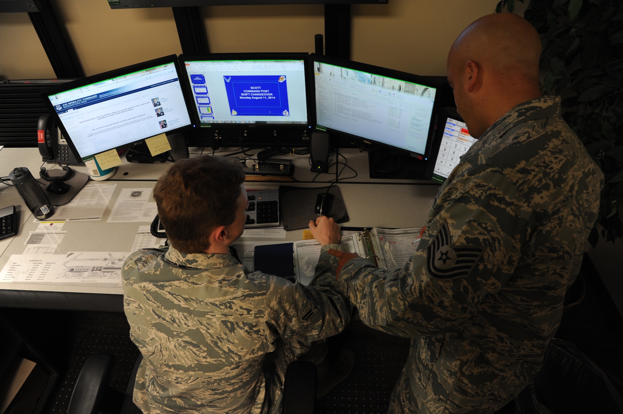Command Post personnel look over a checklist at the Command Post building at Scott Air Force Base, Ill. The Command Post is one of the focal points for the exercises on base as well as the flightline. The exercises are kicked off from inside the building and anyone who wants access to the flightline must go through them. (U.S. Air Force photo/ Senior Airman Tristin English)