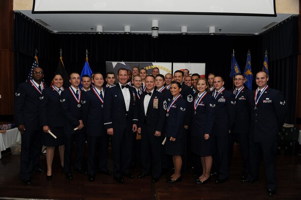 Airman Leadership School class 14-F poses for a group photo during their graduation night celebration. (U.S. Air Force photo by Senior Airman Gustavo Castillo/Released)