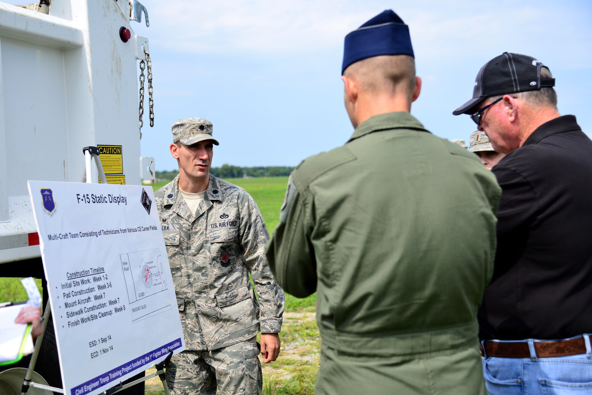 U.S. Air Force Lt. Col. Anthony Figiera, 633rd Civil Engineer Squadron commander, briefs Col. Kevin Huyck, 1st Fighter Wing commander, and Col. (Ret.) James Hardenbrook, 1st Fighter Wing Association president emeritus and F-15 static display project manager, about a Civil Engineer Troop Training Project at Langley Air Force Base, Va., Aug. 7, 2014. Several technicians from various civil engineer career fields will work together to place an F-15 Eagle on display using funds donated by the  1st Fighter Wing Association. According to Figiera, the project will be completed at no cost to the Air Force and will allow Airmen to receive critical training. Base patrons should expect construction to begin in early September and last until November. (U.S. Air Force photo by Senior Airman Aubrey White/Released)