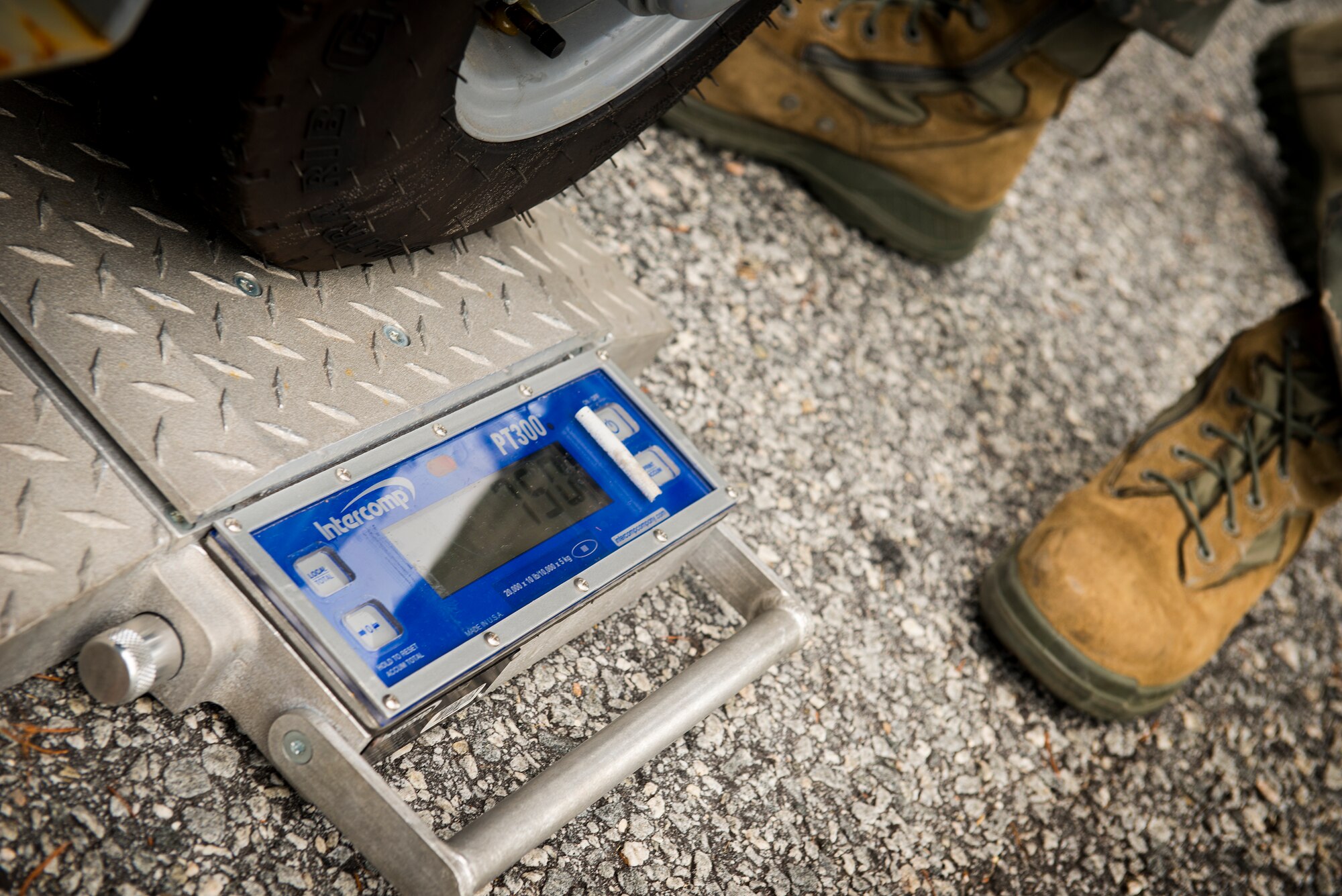 Airmen from the 23d Logistics Readiness Squadron use a scale to weigh cargo as part of a cargo deployment function exercise at Moody Air Force Base, Ga., Aug. 19, 2014. Each piece of cargo had to be weighed and measured to ensure safe transport aboard an aircraft. (U.S. Air Force photo by Airman 1st Class Ryan Callaghan/Released)