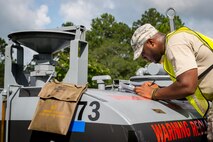 U.S. Air Force Senior Airman Dextrian Gunn, 23d Logistics Readiness Squadron, records measurements onto a cargo placard during a cargo deployment function exercise at Moody Air Force Base, Ga., Aug. 19, 2014. After the units delivered their equipment to the cargo staging yard, Gunn validated the weight and dimensions before sending it to the flightline. (U.S. Air Force photo by Airman 1st Class Ryan Callaghan/Released)