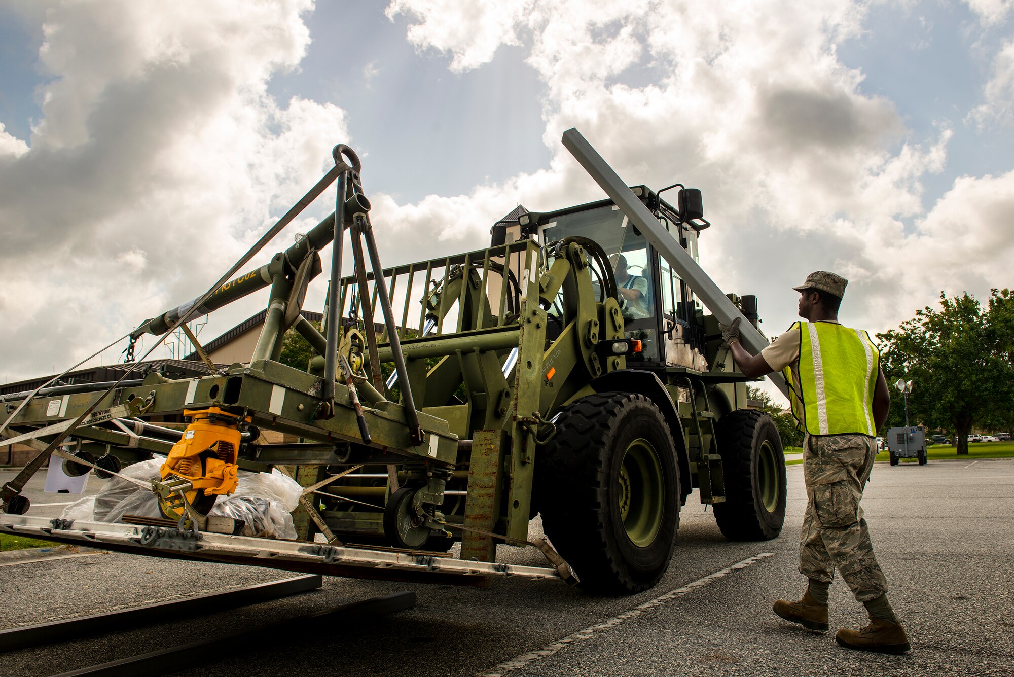U.S. Air Force Senior Airman Gregory McMillan, 23d Logistics Readiness Squadron, loads palate supports onto a forklift during a cargo deployment function exercise at Moody Air Force Base, Ga., Aug. 19, 2014. The exercise tested the 23d Wing’s ability to deploy equipment in addition to Airmen. (U.S. Air Force photo by Airman 1st Class Ryan Callaghan/Released)
