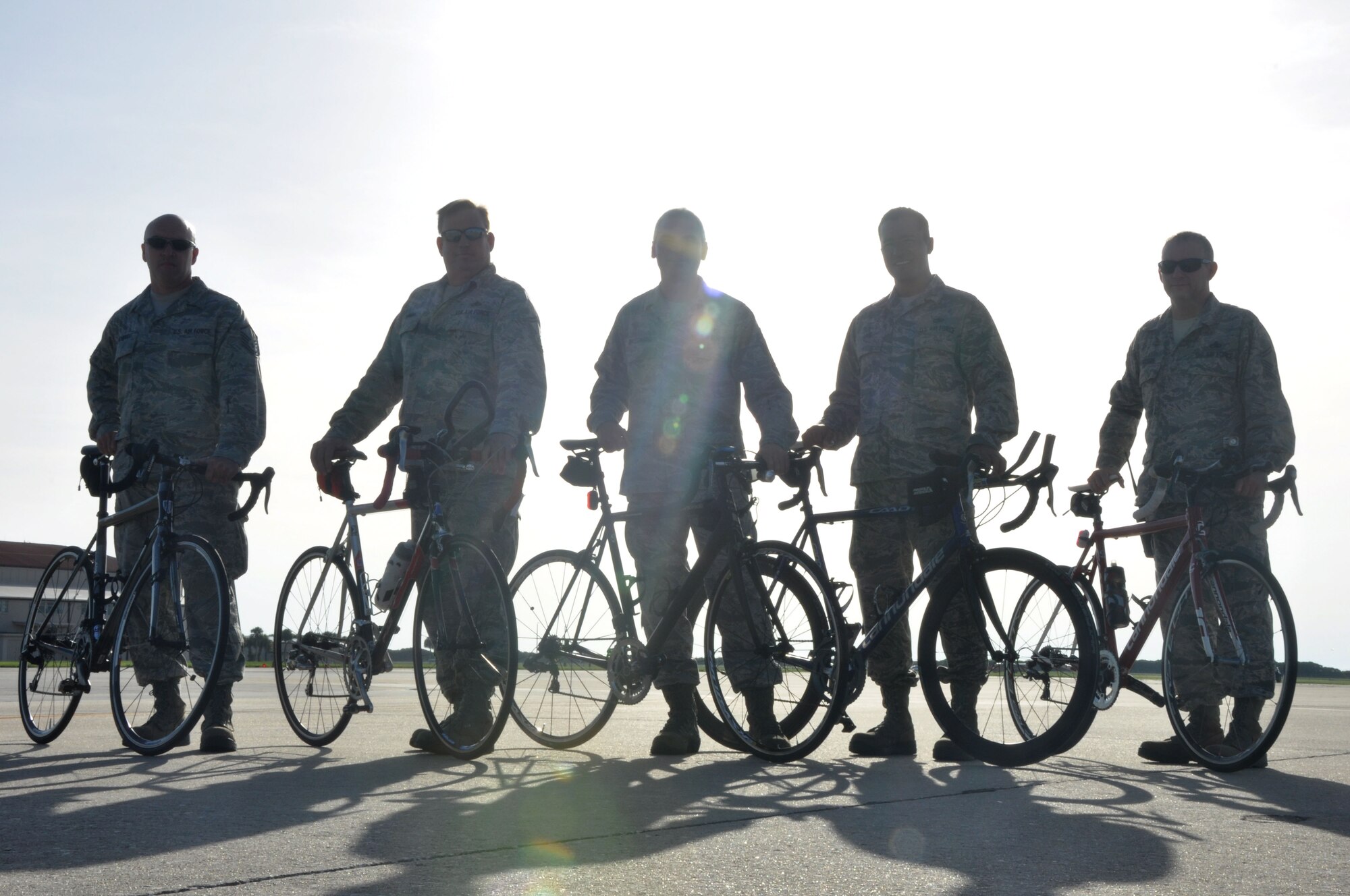 Members from the 920th Maintenance Squadron pose for a picture on the flightline, Patrick Air Force Base, Fla., August 19, 2014. The members are part of a cycling club and plan to participate in the Rocketman Florida Triathlon, October 12, 1014. (U.S. Air Force photo/ Tech. Sgt. Katie Spencer) 