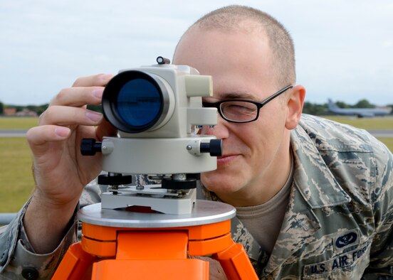U.S. Air Force Senior Airman Logan Fountaine, 100th Civil Engineer Squadron engineering assistant from Ontario, N.Y., adjusts the sights on a measuring tool Aug. 18, 2014, on RAF Mildenhall, England. Fountaine was performing a yearly inspection which measures the amount of soil on top of a munitions igloo. (U.S. Air Force photo/Airman 1st Class Victoria H. Taylor/Released)