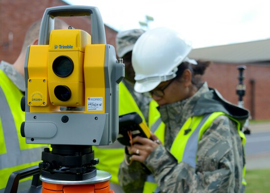 Airmen from the 100th Civil Engineer Squadron input data into a geodimeter Aug. 18, 2014, on RAF Mildenhall, England. The machine is used to easily and precisely measure distances up to a mile long using laser technology. (U.S. Air Force photo/Airman 1st Class Victoria H. Taylor/Released)