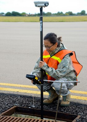 U.S. Air Force Airman 1st Class Abigail Slater, 100th Civil Engineer Squadron engineering assistant from Fairfax, Va., inputs data into the portable global network satellite system receiver Aug. 18, 2014, on RAF Mildenhall, England. Slater is in the process of creating a map updating the base’s underground water pipes. (U.S. Air Force photo/Airman 1st Class Victoria H. Taylor/Released)