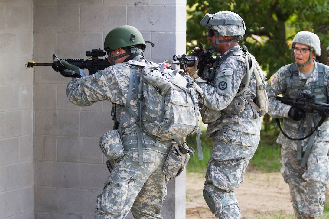 Soldiers provide security during an urban training event on Camp Blanding, Fla., Aug. 19, 2014. 