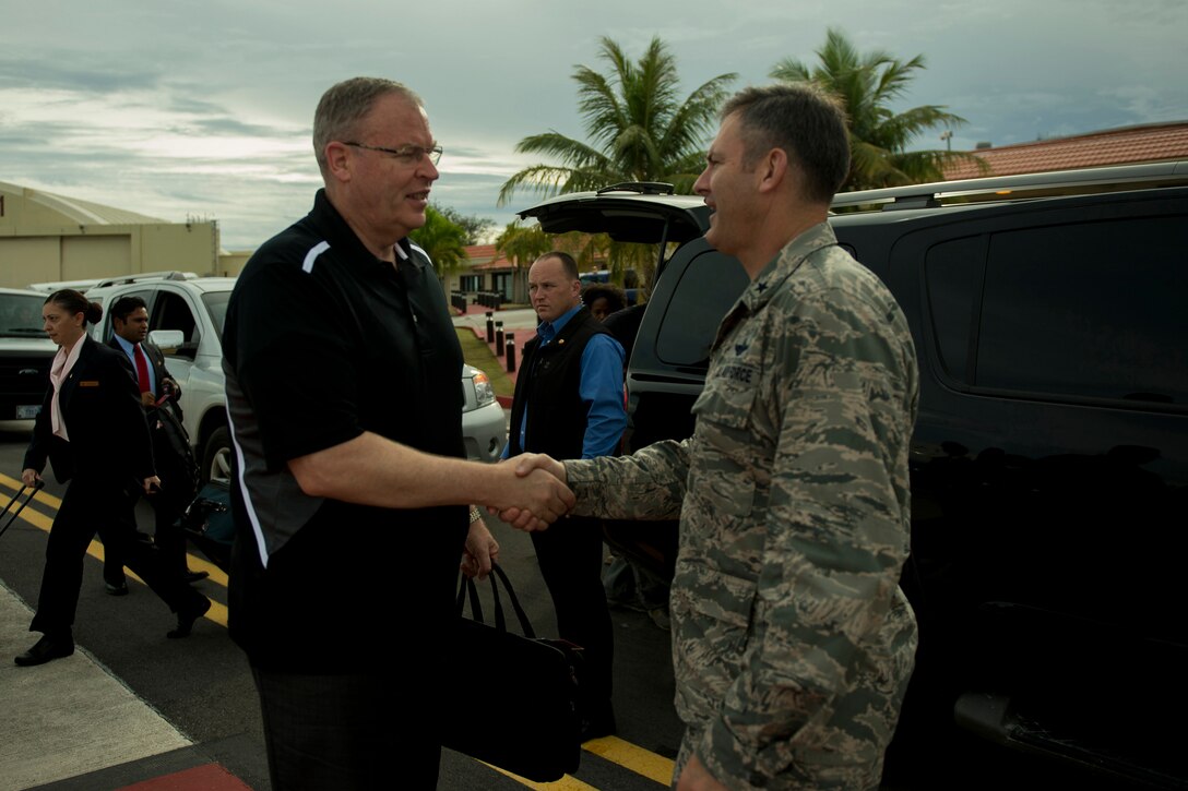 U.S. Deputy Defense Secretary Bob Work shakes hands with U.S. Air Force Brig. Gen. Andrew J. Toth, commander of the 36th Wing, as he prepares to depart Andersen Air Force Base, Guam, Aug. 20, 2014, during a trip to the Asia-Pacific region. 