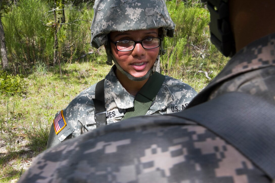 Army Sgt. Kiana Borges talks with a soldier about the nine-line medical evacuation report at the end of the urban training event on Camp Blanding, Fla., Aug. 19, 2014. Borges is an Army medic. 