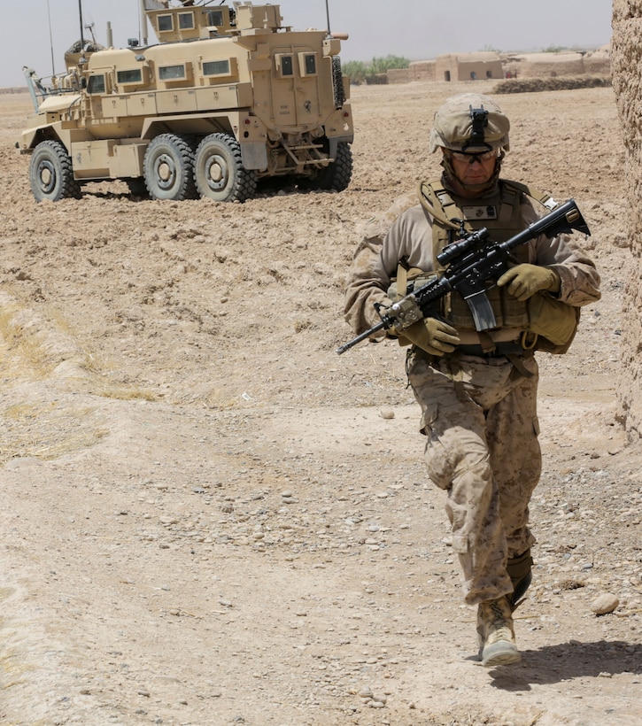 U.S. Marine Corps Sgt. Maj. Robert Pullen walks a security patrol in Nad Ali district in Helmand province, Afghanistan, Aug. 11, 2014.