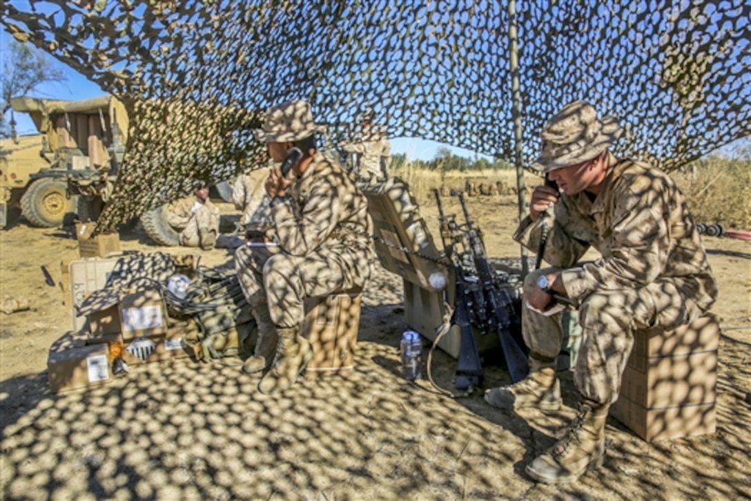 U.S. Marines radio a mass casualty report during Exercise Koolendong on Bradshaw Field Training Area in Australia, Aug. 18, 2014. The focus of the exercise is to establish a headquarters element for U.S. And Audtralian forces to direct ground, aviation and logistics capabilities in austere conditions. 