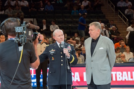 Chairman of the Joint Chiefs of Staff Gen. Martin E. Dempsey introduces service members before they presented "dog-tags" to members of the U.S. national mens basketball team before their exhibition game against the Dominican Republic at Madison Square Garden in New York city Aug. 20, 2014.