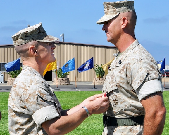 Col. James Adams, commanding officer of Marine Aviation, Weapons and Tactics Squadron 1, presents the Legion of Merit to Sgt. Maj. Kenneth Warren following an Aug. 14 relief and appointment ceremony for Marine Corps Tactical Systems Support Activity at Camp Pendleton, California. Warren retired after 30 years of service to the Corps and Sgt. Maj. Brandon C. Hall was appointed as the activity's new sergeant major. 