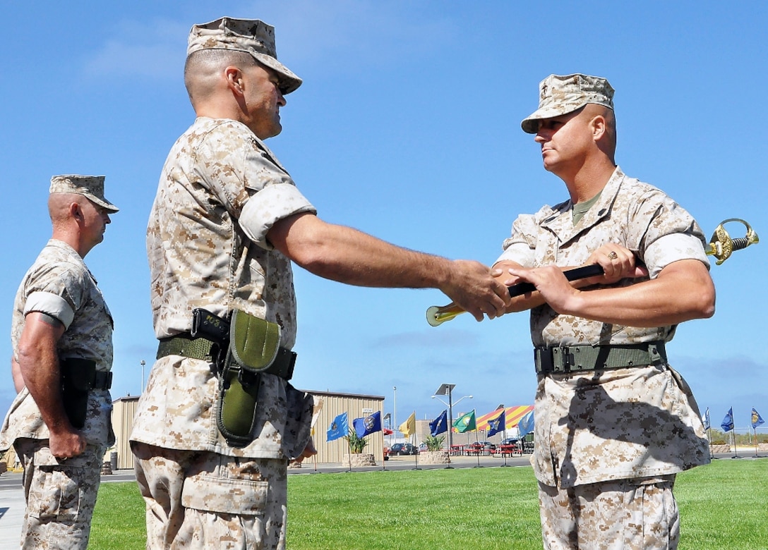 Passing ceremonial sword to MCTSSA's new sergeant major