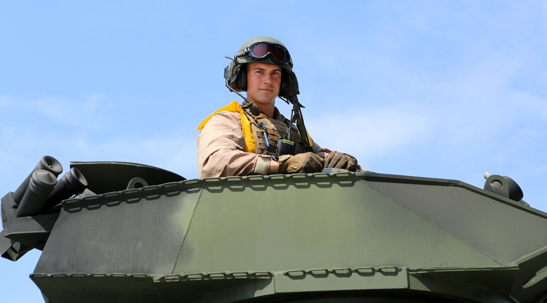 2nd Lt. Ryan Schab, platoon commander with Company D, 4th Assault Amphibian Battalion, 4th Marine Division, mans the turret of an AAV after conducting ship-to-shore operations with Reserve Marines of 4th AAV Bn. at Blount Island, Jacksonville, Fla., Aug. 13, 2014. The training focused on amphibious training and the ability to splash off ship and drive to shore. The Reserve Marines also focused on interoperability with the Navy, using their Maritime Prepositioning Ship to launch the AAVs. 