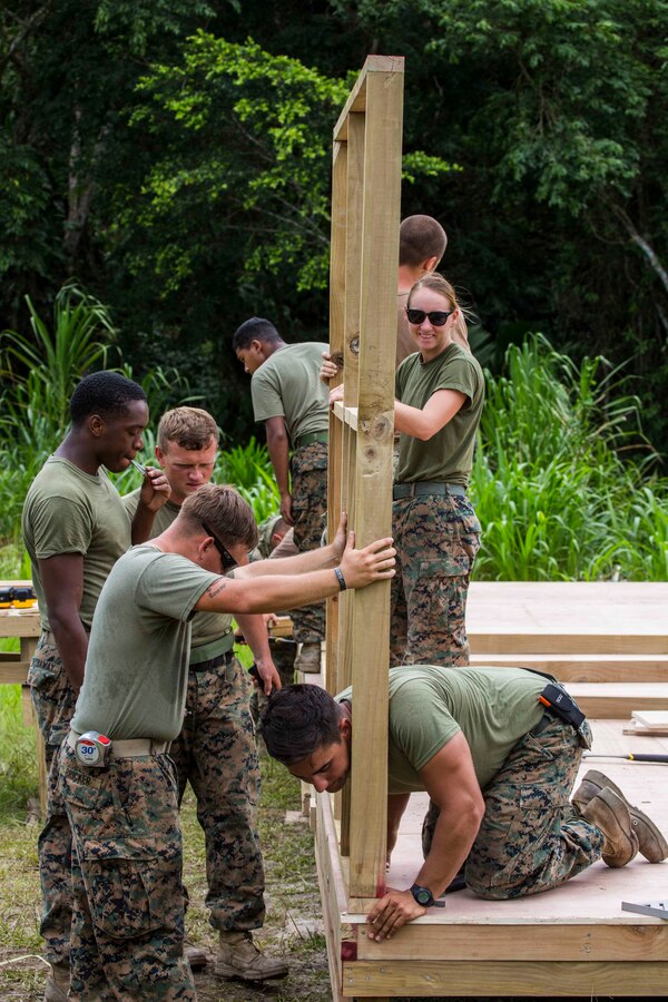 U.S. Marines with 8th Engineer Support Battalion (ESB) construct a South West Asia (SWA) hut. The SWA hut is being built as a multi-purpose classroom for the Brigada De Infantería de Marina (BIM) at the BIM base, Puerto Barrios, Guatemala, Aug. 12, 2014. The Combat Engineers are part of Southern Partnership Station 14, a combined joint exercise focused on subject matter expert exchanges with partner nations and security forces as well as military to military engagements and community relations projects in Central America. (U.S. Marine Corps photo by Cpl. Nicholas T. Nohalty, 2D MARDIV Combat Camera/Released)