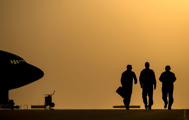 Capts. Andrea Delosreyes and Trent Parker and Airman 1st Class Kevin Haggith walk the flightline Aug. 11, 2014, after taking part an in-air refueling mission over Iraq. The aircrew unloaded 40,000 gallons of fuel to aircraft completing missions in Iraq. President Barack Obama authorized humanitarian aid deliveries to Iraq as well as targeted airstrikes to protect U.S. personnel from Islamic extremists. U.S. Central Command directed the operations. Delosreyes and Parker are pilots and Haggith is a boom operator with the 340th Expeditionary Air Refueling Squadron (U.S. Air Force photo/Staff Sgt. Vernon Young Jr.)
