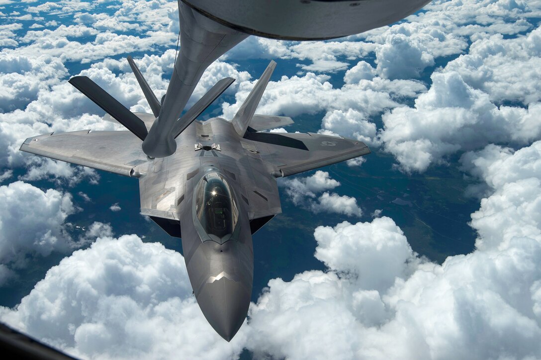 An F-22 Raptor performs a refueling  with a KC-135 Stratotanker during a training mission Aug. 7, 2014, near Joint Base Elmendorf-Richardson, Alaska. The F-22 is designed to project air dominance, rapidly and at great distances. The F-22 is assigned to the 525th Fighter Squadron and the KC-135 is from McConnell Air Force Base, Kan. (U.S. Air Force photo/Staff Sgt. Stephany Richards)
