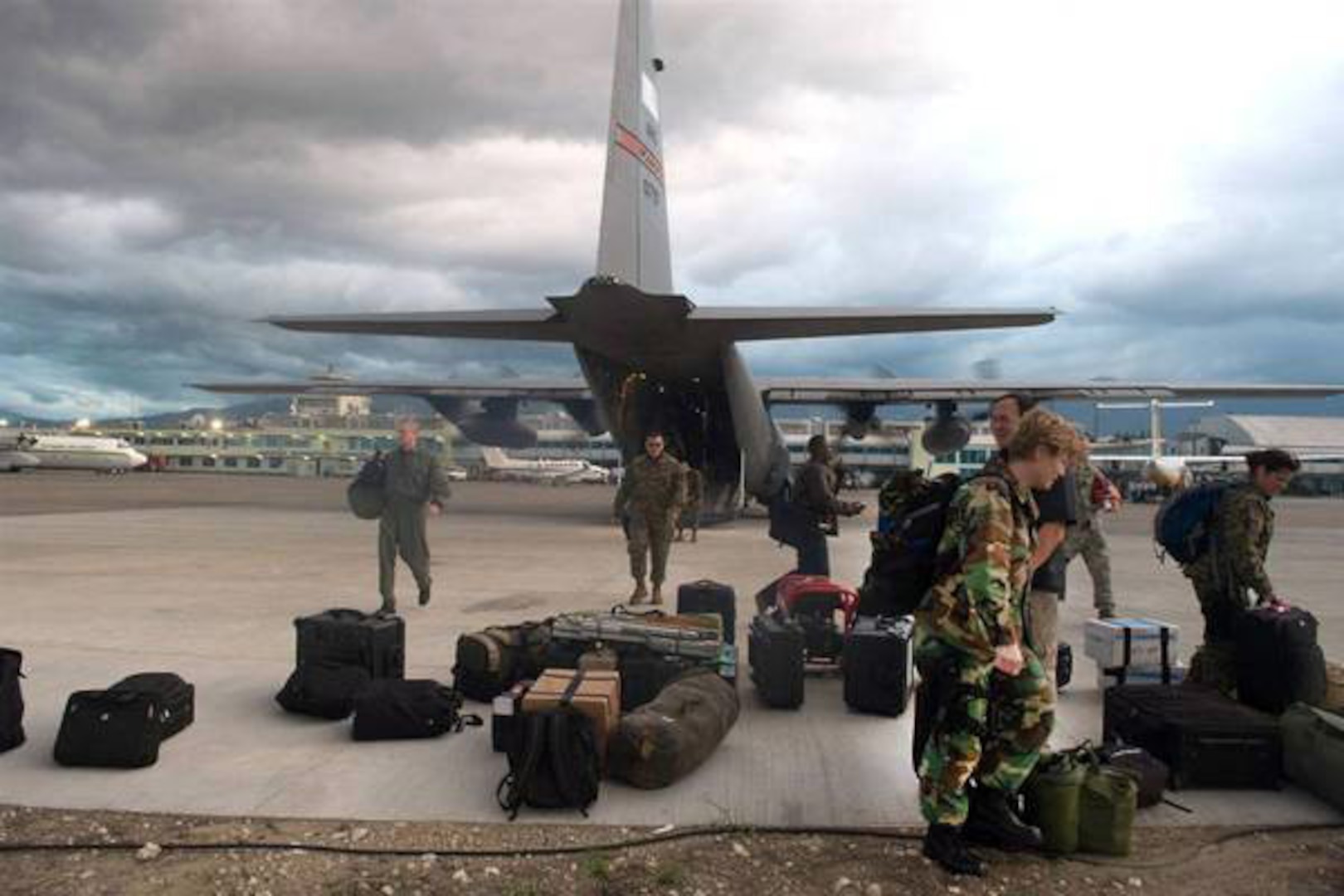 Airmen from the 179th Airlift Wing of the Ohio Air National Guard unload supplies Jan. 13 from their C-130 Hercules cargo aircraft. They were the first to land in Port-au-Prince following a devastating magnitude 7.0 earthquake Jan. 12, 2009. Two C-130 aircraft and five air crews from the Mansfield unit are currently supporting relief efforts.