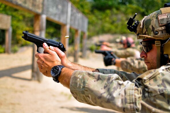 Staff Sgt. Nathan A. Hruska fires his Beretta M9 pistol during a weapons qualification Aug. 15, 2014, at Operation Northern Strike in Alpena, Mich. Northern Strike was a 3-week exercise led by the National Guard that demonstrated the combined power of joint and multinational air and ground forces. Hruska is a tactical air control party specialist with the 169th Air Support Operations Squadron. TACPs were with the Air National Guards 169th ASOS from Peoria, Ill., and more than 5,000 other armed forces members from 12 states and two coalition nations participated in the combat training. (U.S. Air National Guard photo/Staff Sgt. Lealan Buehrer) 
