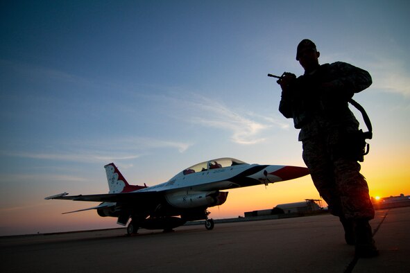 Staff Sgt. Luis Rodriguez from the New Jersey Air National Guard's 177th Security Forces Squadron conducts an early morning walk-around of a Thunderbirds  F-16D Fighting Falcon Aug. 11, 2014, at Atlantic City Air National Guard Base, N.J. The Thunderbirds are the premier flying demonstration group and performed for the Atlantic City "Thunder Over the Boardwalk Airshow" Aug. 13.  (U.S. Air National Guard photo/Tech. Sgt. Matt Hecht) 
