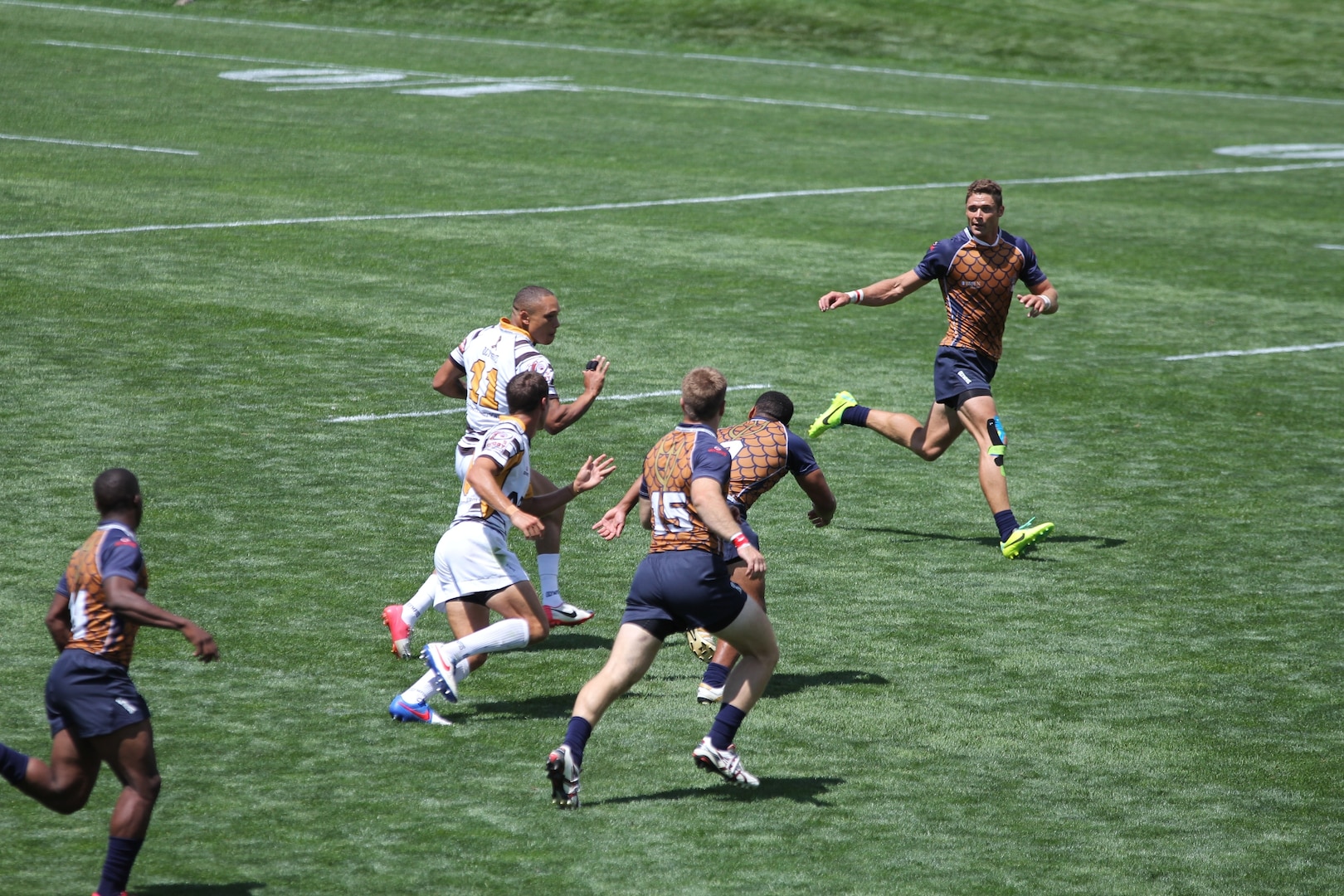 Army Spec. Stephen Johnson (#11) from Fort Bragg, NC looks for a hole to break through during Army's 28-12 victory over Navy at the 2014 Armed Forces Rugby 7’s Championship in Glendale, Colo. 15-17 August.