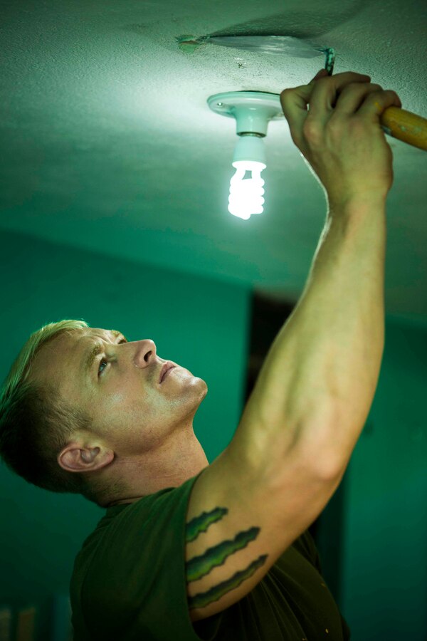 U.S. Marine Corps Cpl. Michael Merrifield, a metal worker from 8th Engineer Support Battalion, 2nd Marine Logistics Group fills in holes in the ceiling with stucco in order to paint over them later on. The Guatemalan Brigada de Infanteria de Marina (BIM) engineers along with their U.S. counterparts help renovate the Biblioteca Municipal Corporacion 74-78 as part of a humanitarian engineering project in Puerto Barrios, Guatemala, Aug. 14, 2014. The Marines and Sailors are helping to remodel buildings in support of Southern Partnership Station 2014, a combined joint exercise focused on subject matter expert exchanges with partner nations and security forces as well as military to military engagements and community relations projects in Central America. (U.S.  Marine Corps photo by Lance Cpl. Chloe Nelson, 2D MAR DIV Combat Camera/ Released)