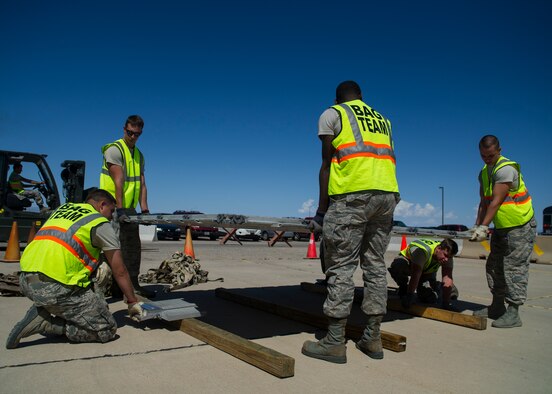 Members of Holloman Air Force Base participate in an exercise Aug. 19, 2014, at Holloman AFB, N.M. The exercise was a part of the Air Force’s Commanders Inspection Program. The program is designed to test a unit’s ability to accomplish the mission with little warning, and provides feedback on areas of excellence or areas that need improvement. The program specifically focuses on the bases ability to rapidly deploy combat-ready Airmen and equipment worldwide. (U.S. Air Force photo/Senior Airman Leah Ferrante)